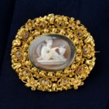 An early to mid 19th century gold shell cameo brooch with cannetille surround set with foil-back