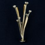 A brilliant-cut diamond stick pin.