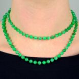 A graduated jade bead single-strand necklace, with old-cut diamond floral cluster clasp.
