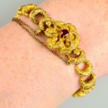 An early 19th century 15ct gold, foliate-embossed crescent shape link bracelet, with