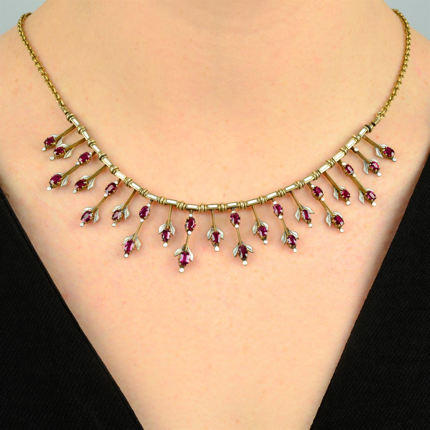 A late Victorian gold, ruby and white enamel fringe necklace.