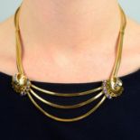 A 1960s 18ct gold multi-strand necklace, gathered to sapphire scrolls.