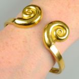 A cuff bangle with shell motif terminals, by Ilias Lalaounis.