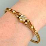 An early 20th century 18ct gold split pearl and old-cut diamond cluster hinged bangle.