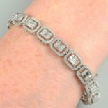 A vari-cut diamond cluster link bracelet.