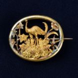 An Australian mid 19th century 18ct gold brooch, c. 1860, depicting an emu amongst native flora.