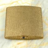 A 1960s 9ct gold textured powder compact with sapphire cabochon clasp.