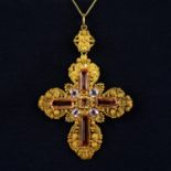 An early 19th century gold, pink and golden topaz cross pendant, with cannetille surround.