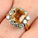 An orange topaz and brilliant-cut diamond cluster ring.
