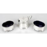 A pair of 1920's silver open salts with blue glass liners, together with a 1930's silver mustard