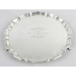 A small Edwardian silver salver with presentation engraving.