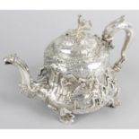 An early Victorian silver teapot profusely decorated with tavern scenes.