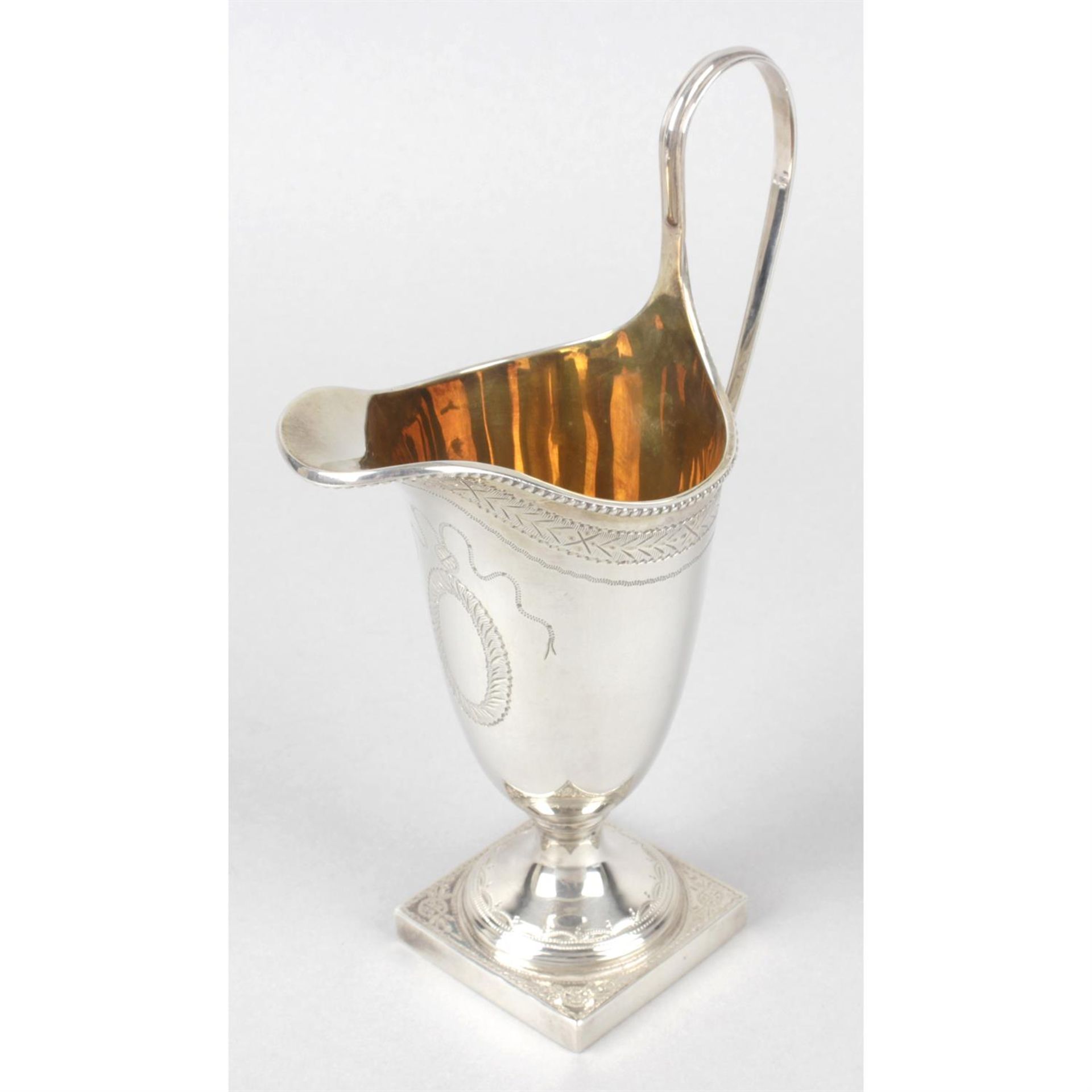 A modern silver reproduction cream jug in George III style.