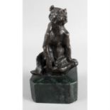 A bronze figure modelled as a seated bear.