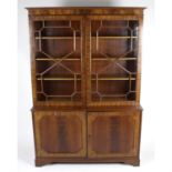 An early 20th century mahogany wardrobe, together with triple door wardrobe and bookcase.