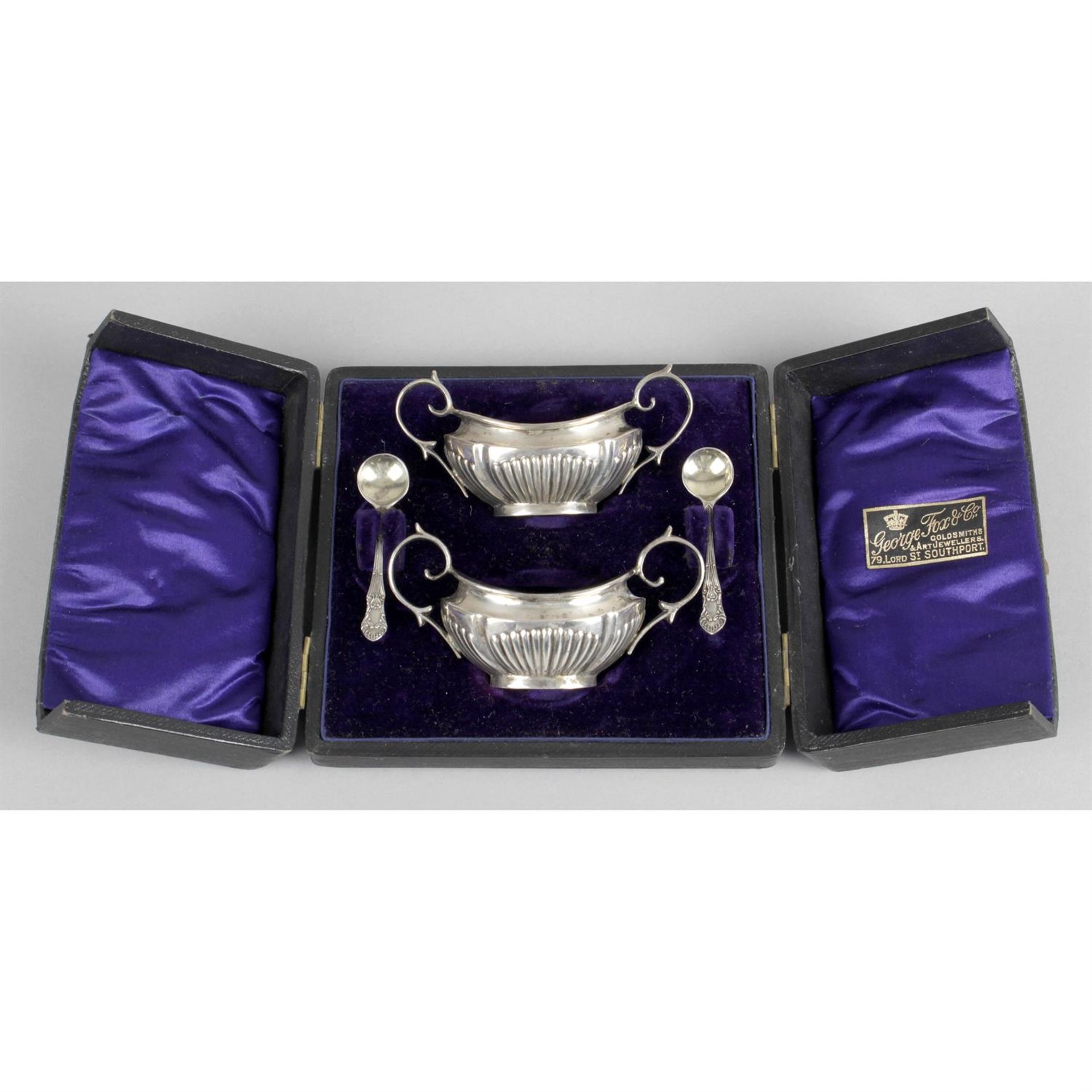 A cased pair of late Victorian silver twin-handled salts with matched spoons, together with a cased