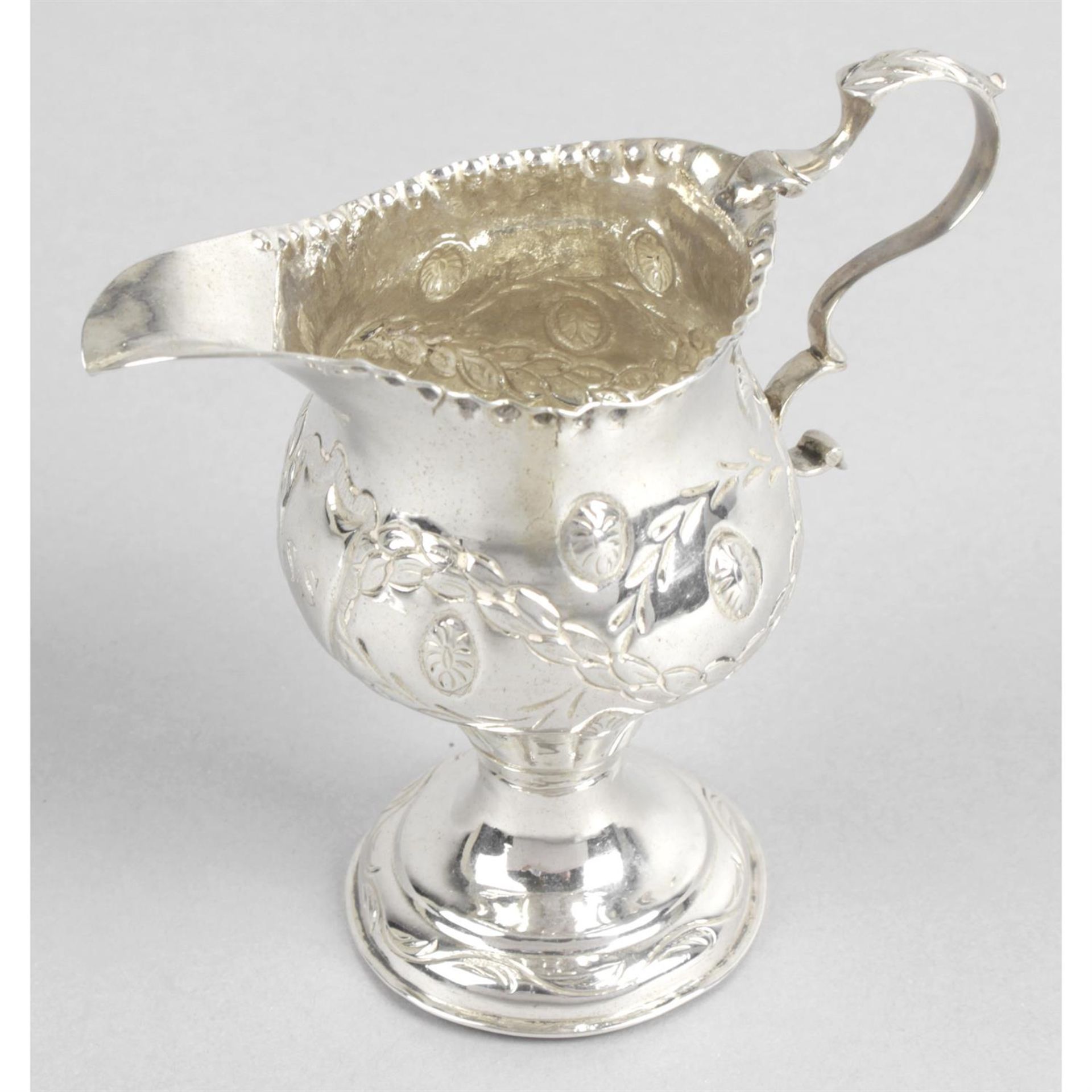 A George III silver pedestal cream jug.