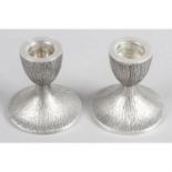 A pair of modern silver dwarf candlesticks.