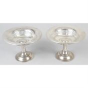 A pair of Edwardian silver pedestal dishes.