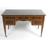 An Edwardian mahogany desk.