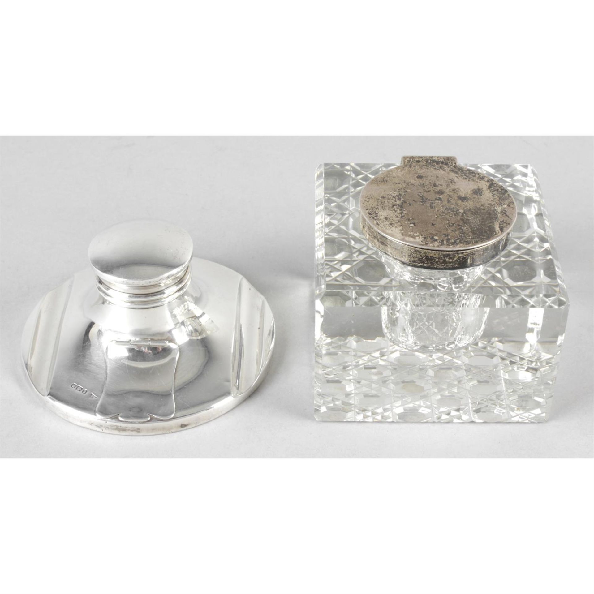 An early 20th century silver mounted capstan inkwell, together with a silver mounted glass inkwell.