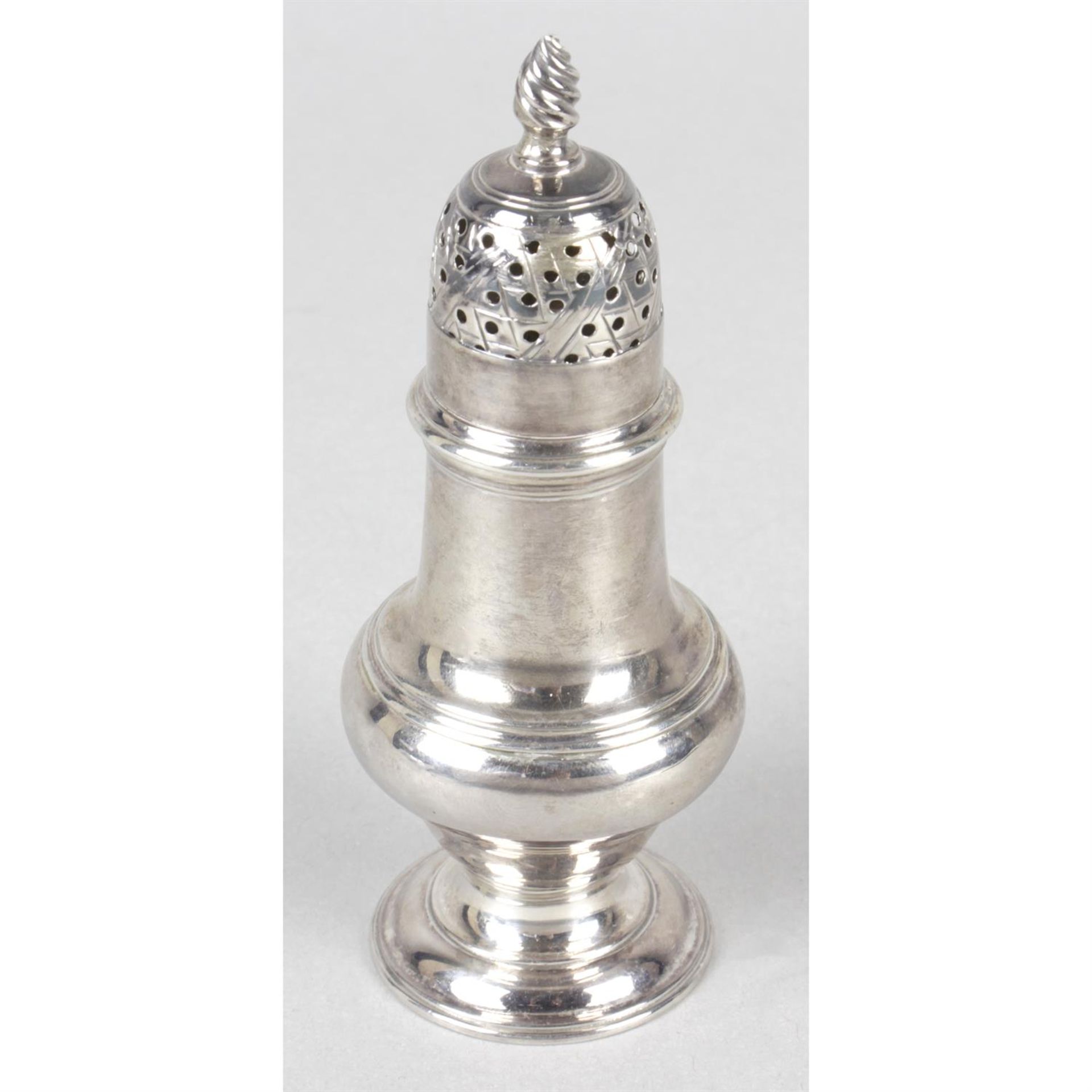 A George III silver pepper caster.