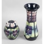 A Moorcroft pottery vase, together with a similar jar and cover. (2)