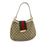 GUCCI - a beige canvas GG hobo handbag.