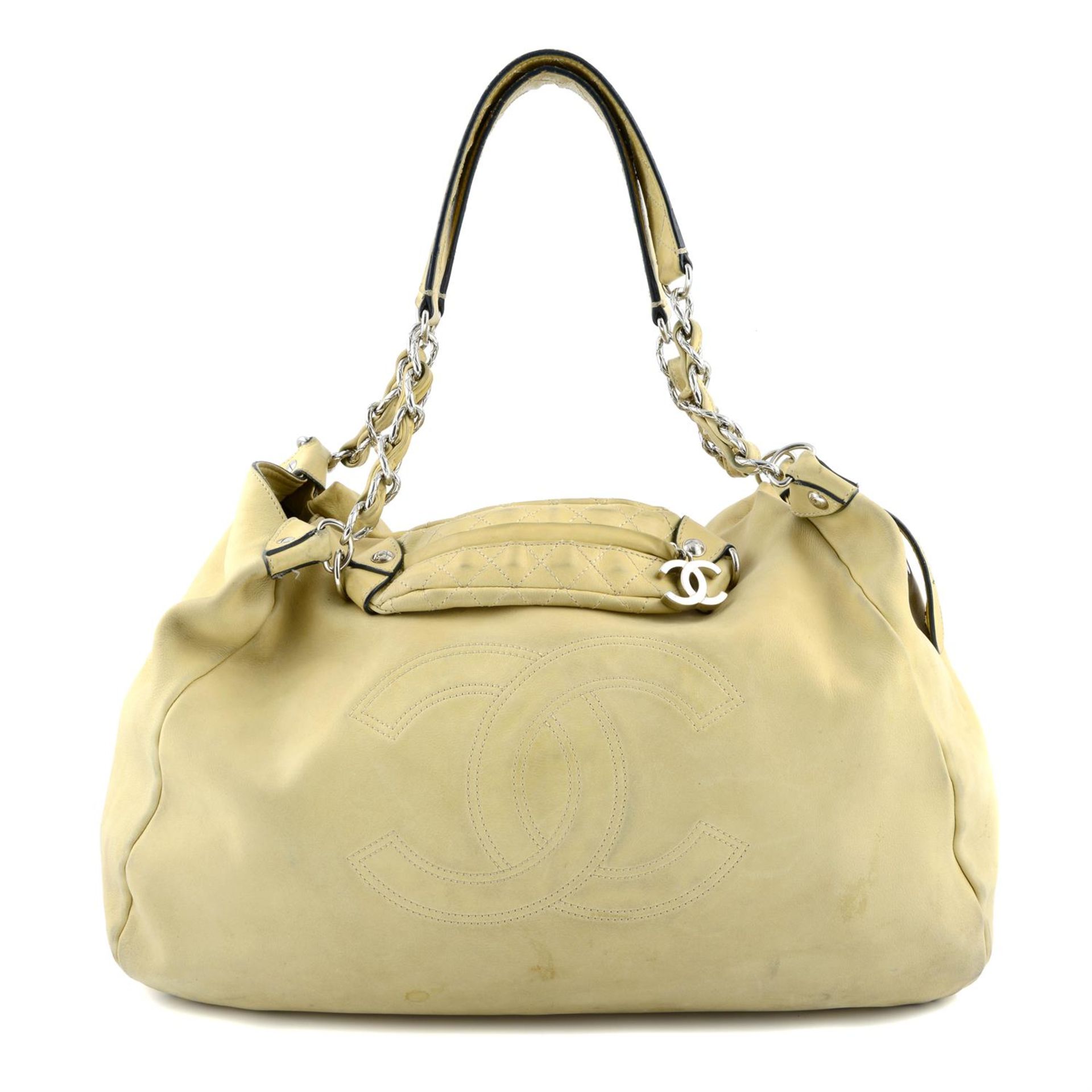 CHANEL - a beige hobo handbag.