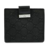 GUCCI: A black leather wallet.