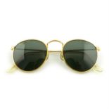 RAY BAN - a pair of sunglasses.