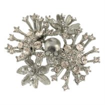 ALEXANDER MCQUEEN - a colourless paste skull and floral spray brooch.