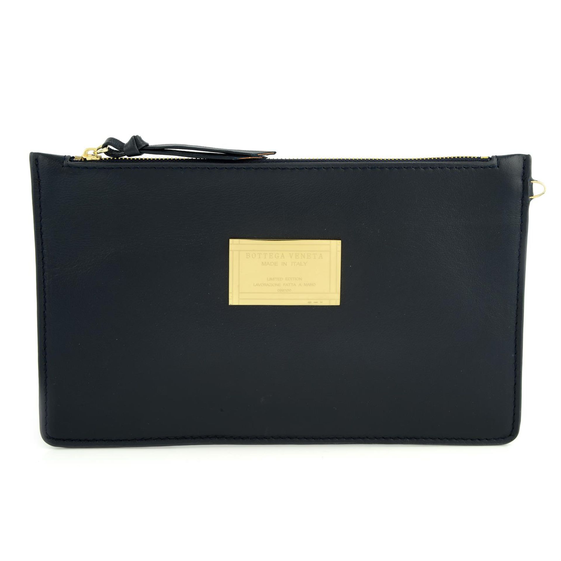 BOTTEGA VENETA- a navy blue clutch bag.