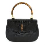GUCCI - a black crocodile leather handbag.