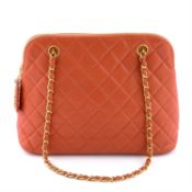 CHANEL - an orange caviar leather handbag.