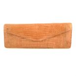 NANCY GONZALES- a beige crocodile clutch bag.