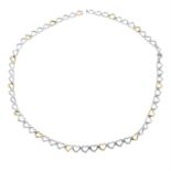 A 9ct gold and silver heart-link necklace, AF.