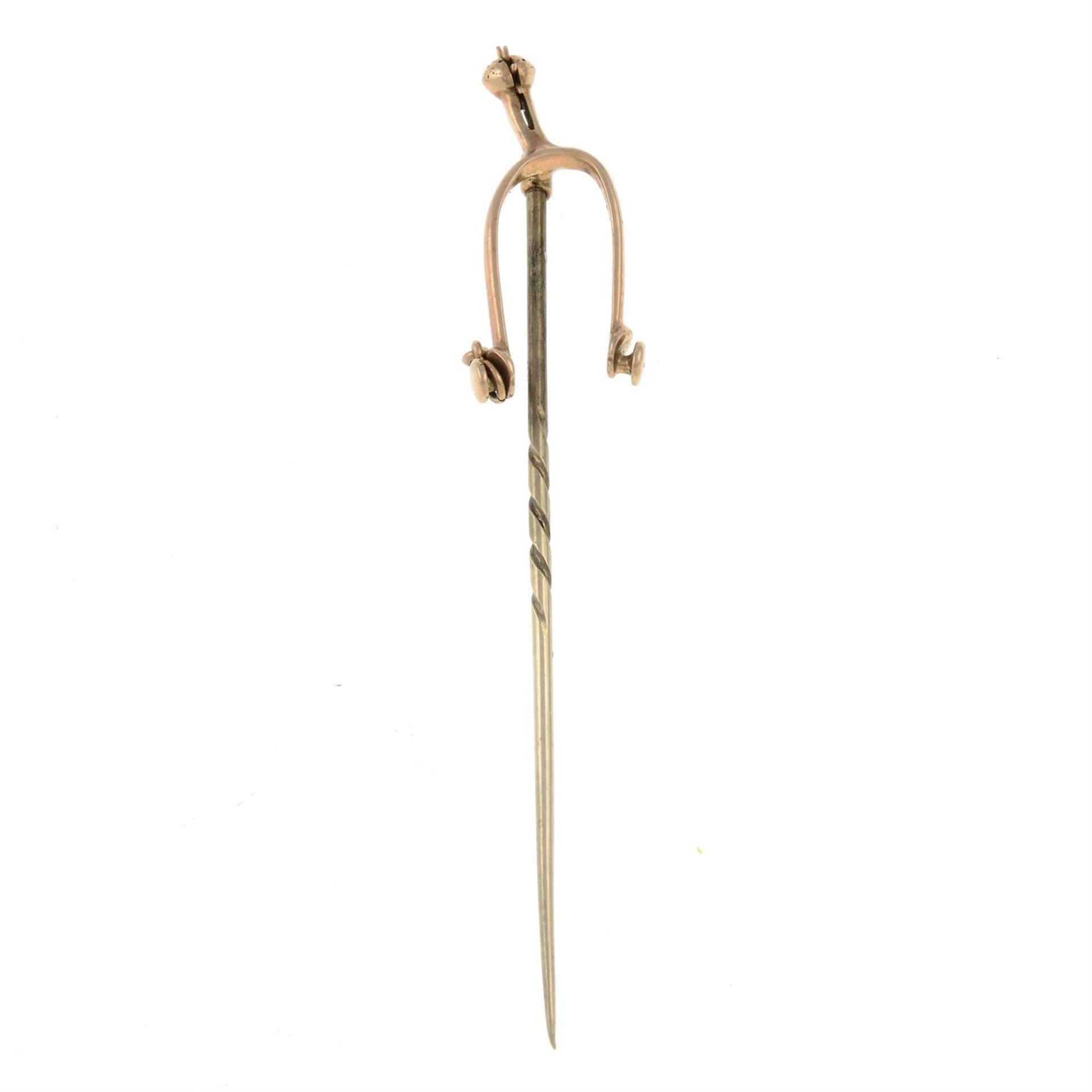 An early 20th century gold riding spur stickpin.