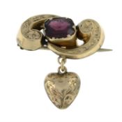 A late 19th century gold garnet brooch, suspending a heart drop.