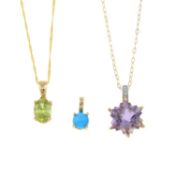 Three gem-set pendants.