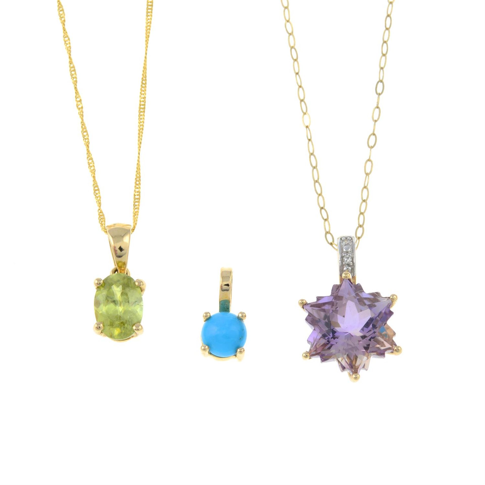 Three gem-set pendants.