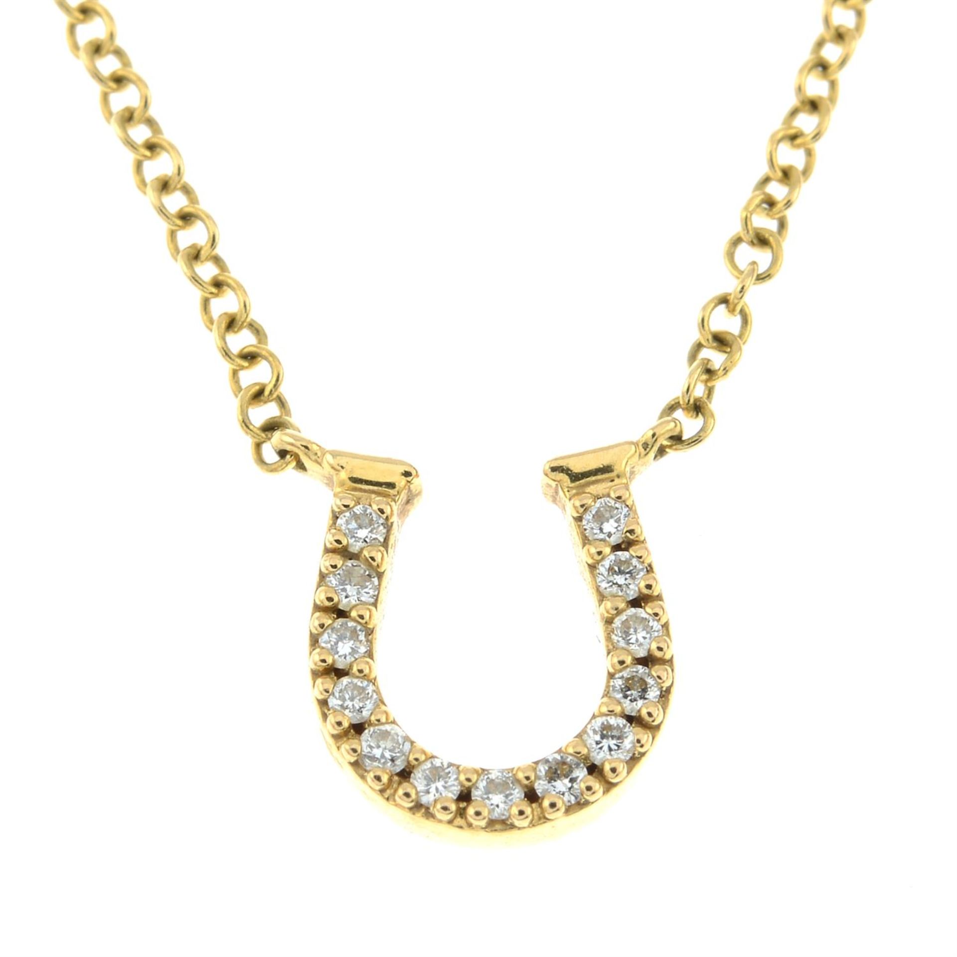 A diamond horseshoe pendant, on an integral trace-link chain, by Tiffany & Co.