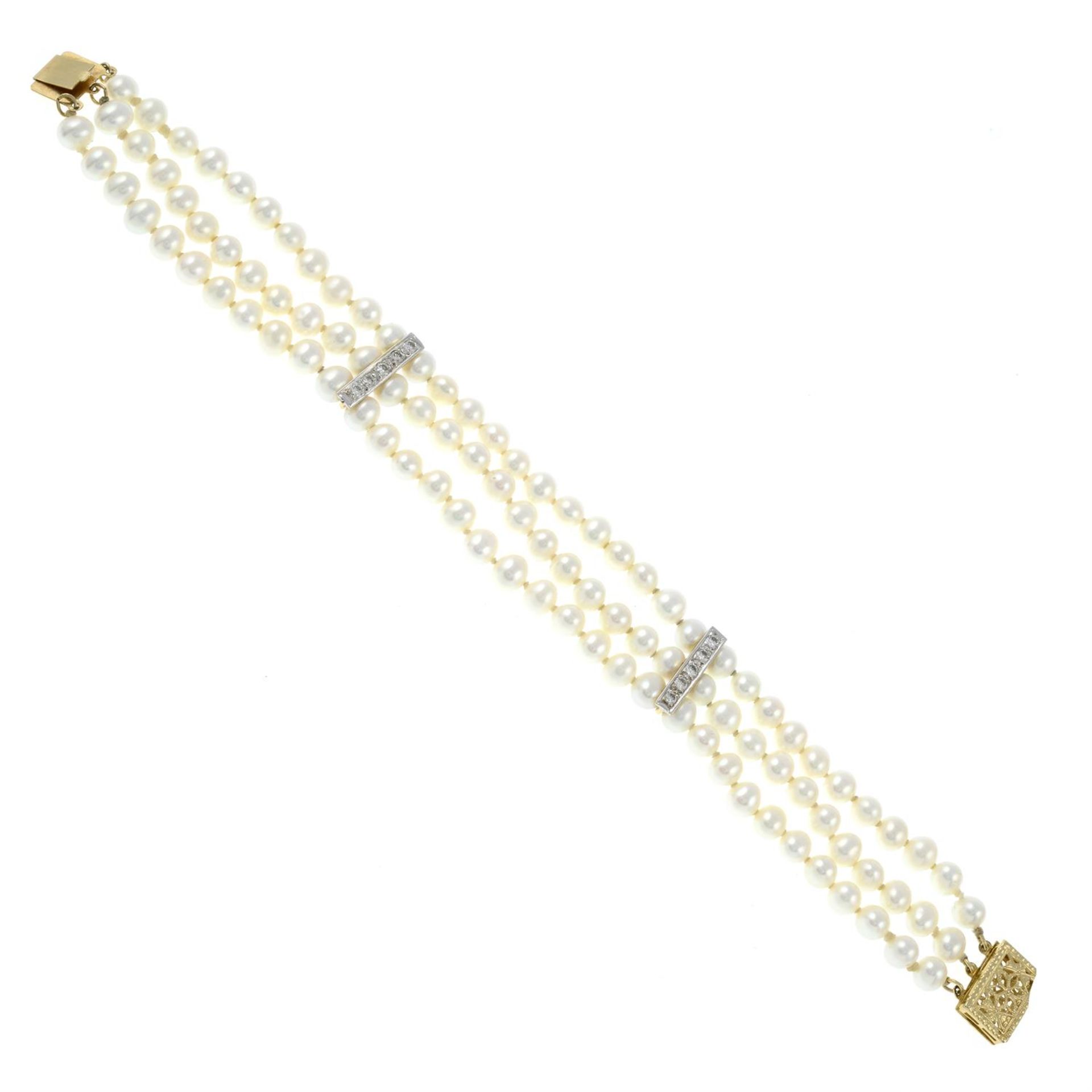 A cultured pearl three-row bracelet, with diamond line spacers and openwork clasp.