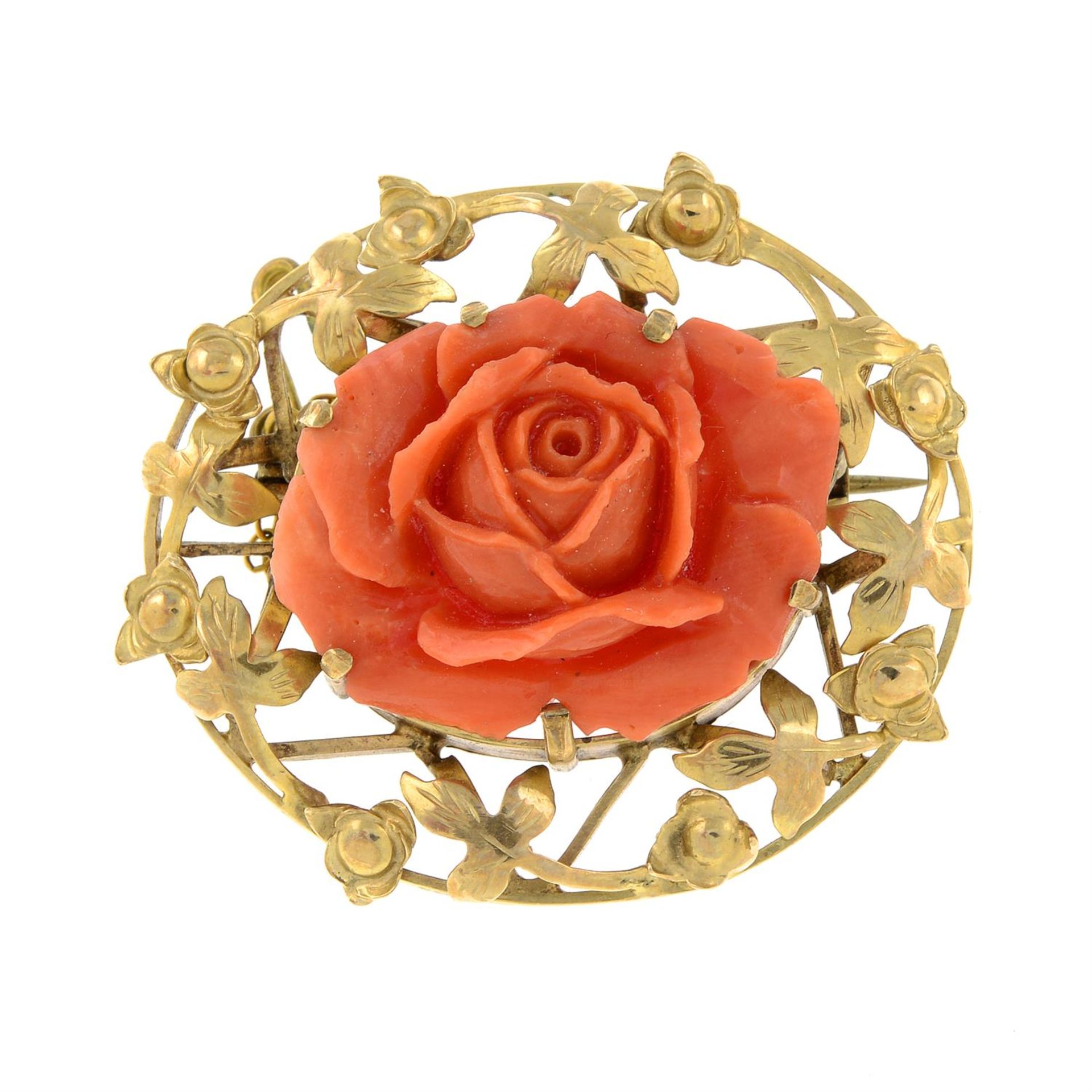A 1960s carved coral rose brooch.