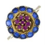 A synthetic blue spinel and ruby floral dress ring.
