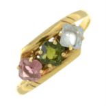 A blue topaz, pink and green tourmaline three-stone ring.