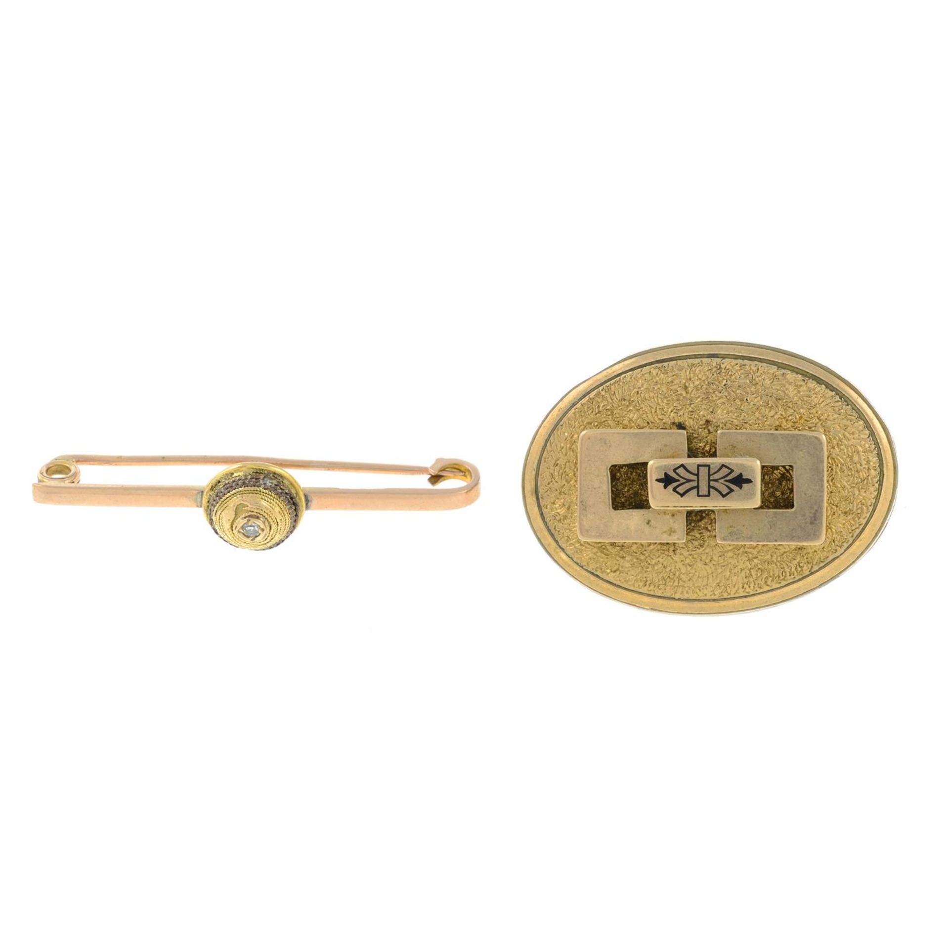 An early 20th century 9ct gold diamond bar brooch and an enamel oval brooch.