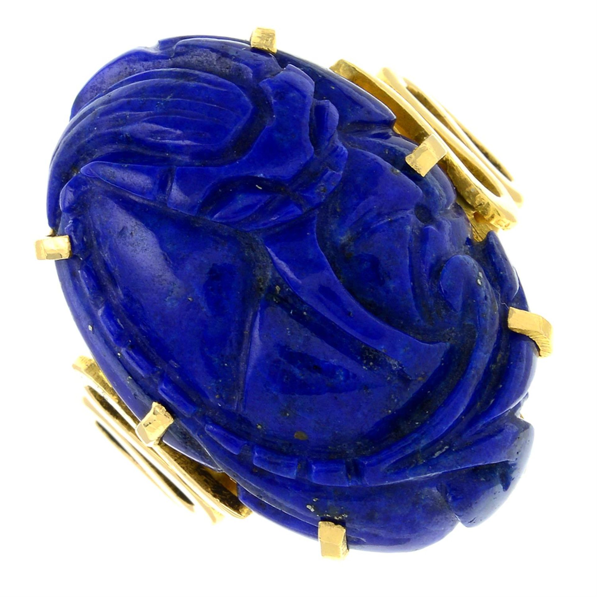 A carved lapis lazuli dress ring.