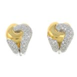 A pair of brilliant-cut diamond knot earrings.