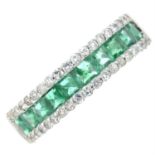 An emerald and diamond half eternity ring.